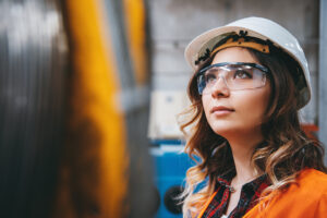 Female engineer in goggles and hi vis jacket