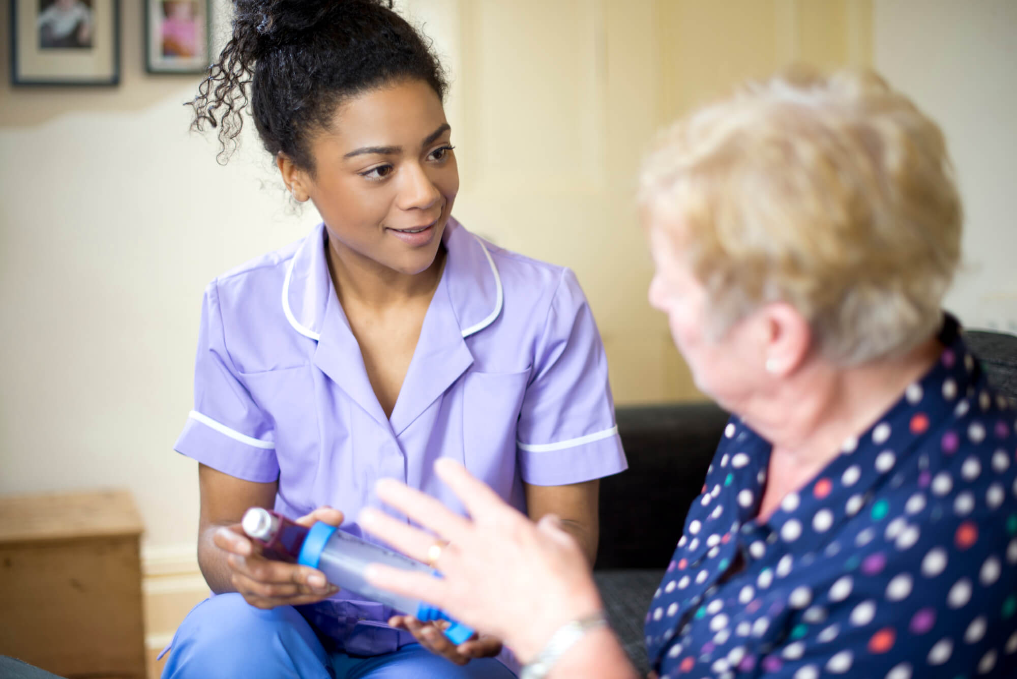 Nurse advising elderly female patient