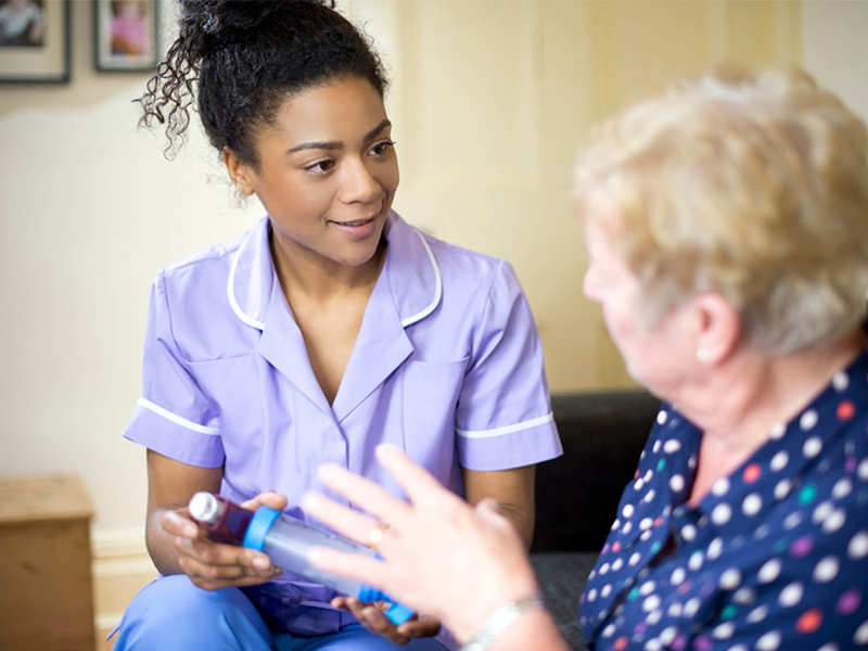 Nurse advising elderly female patient