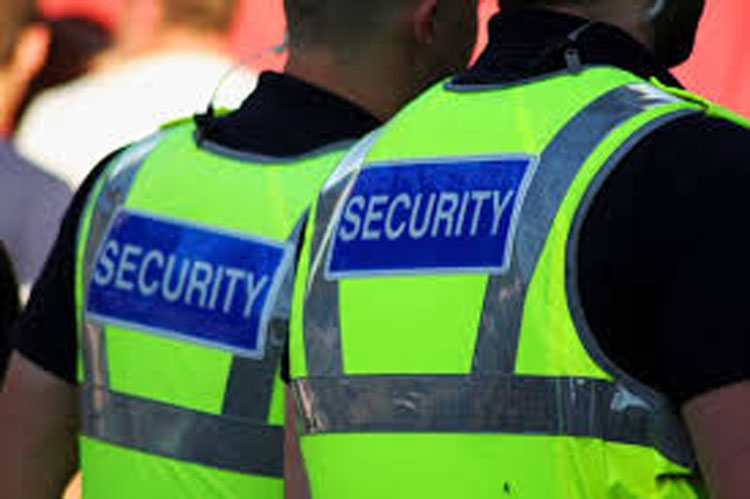 Two male security guards wearing hi vis vests
