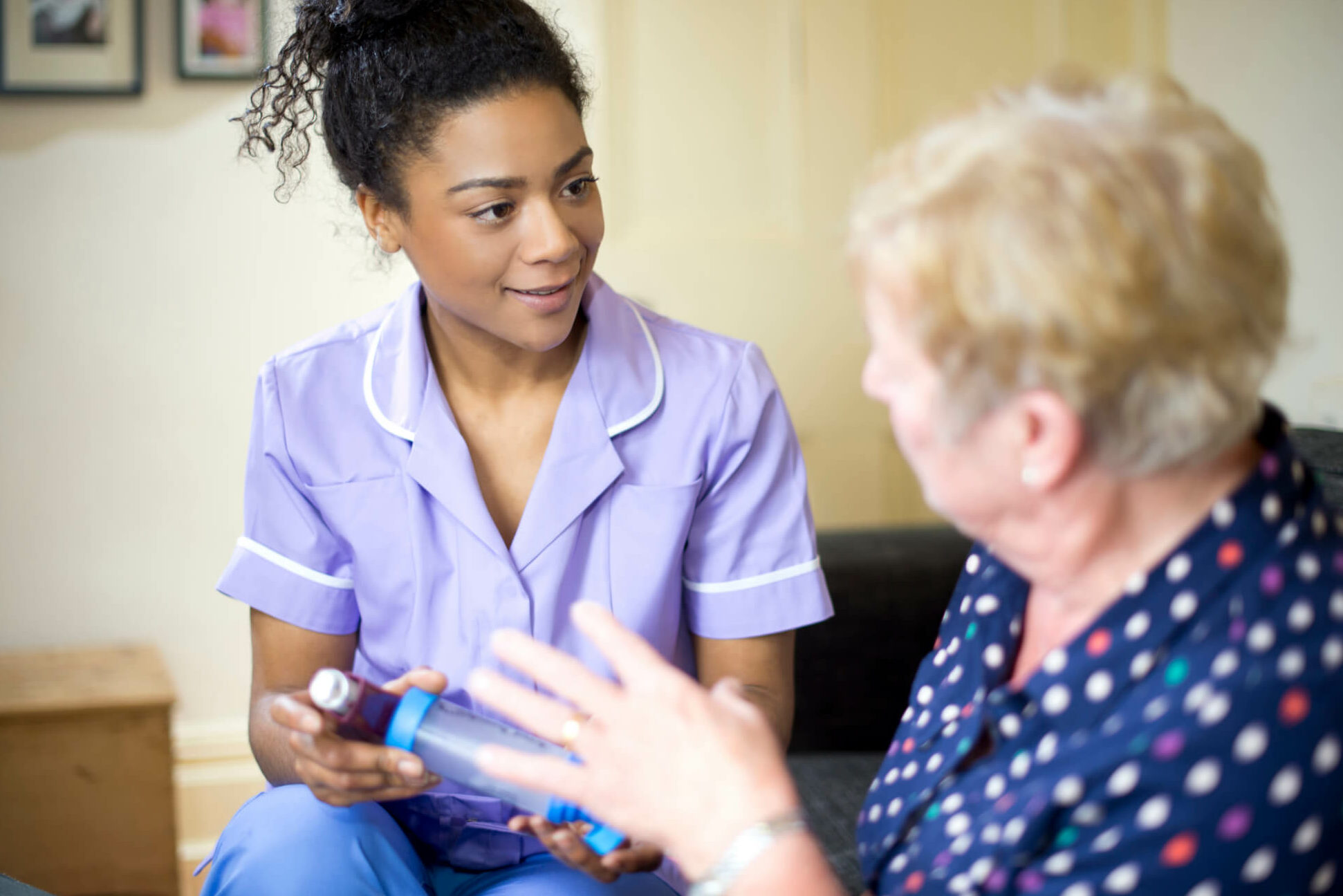 Nurse advising elderly female patient