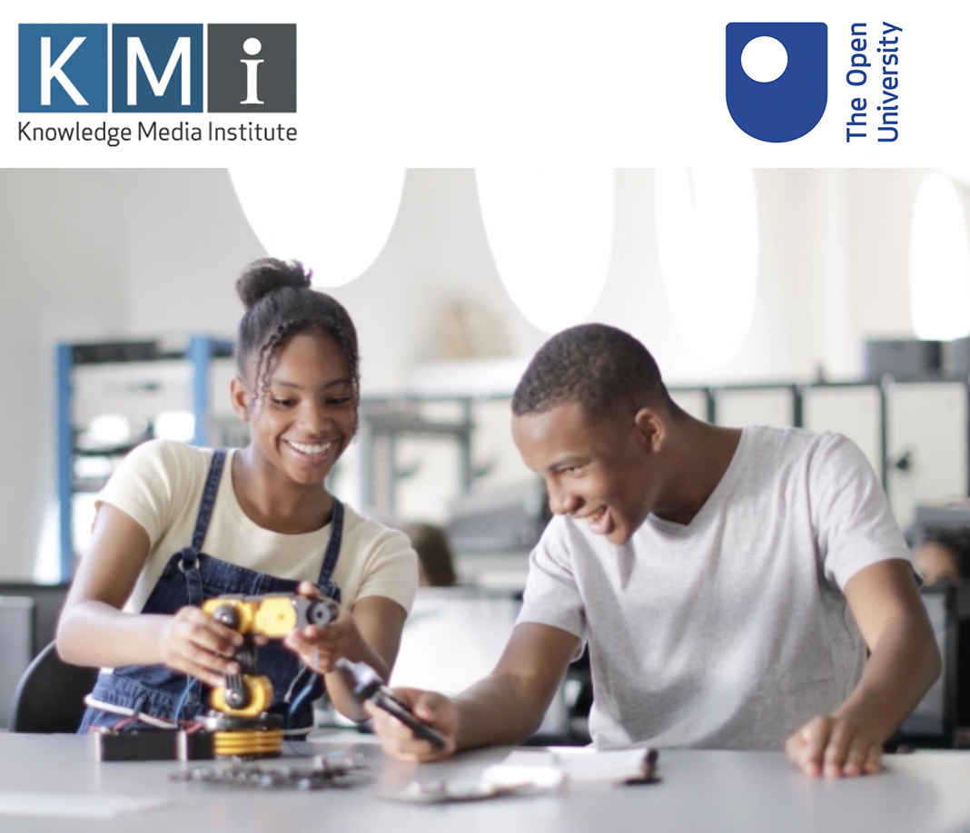 Image of two black students working with a robotic arm