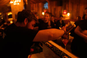 SKILLS BOOTCAMPS ARE TRANSFORMING HOSPITALITY FUTURES Image of male bar attendant mixing cocktails