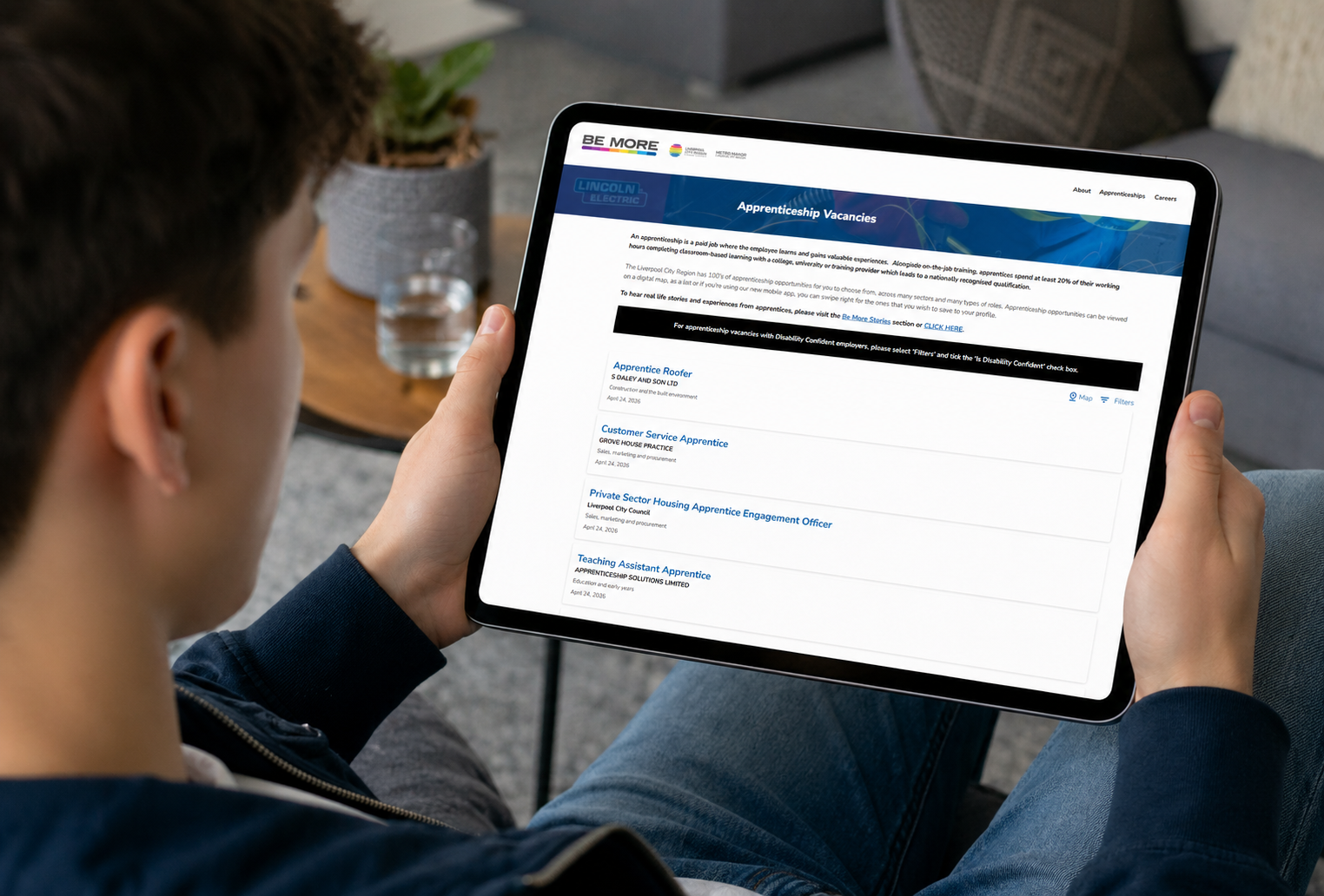 Young male using a tablet to find an apprenticeship